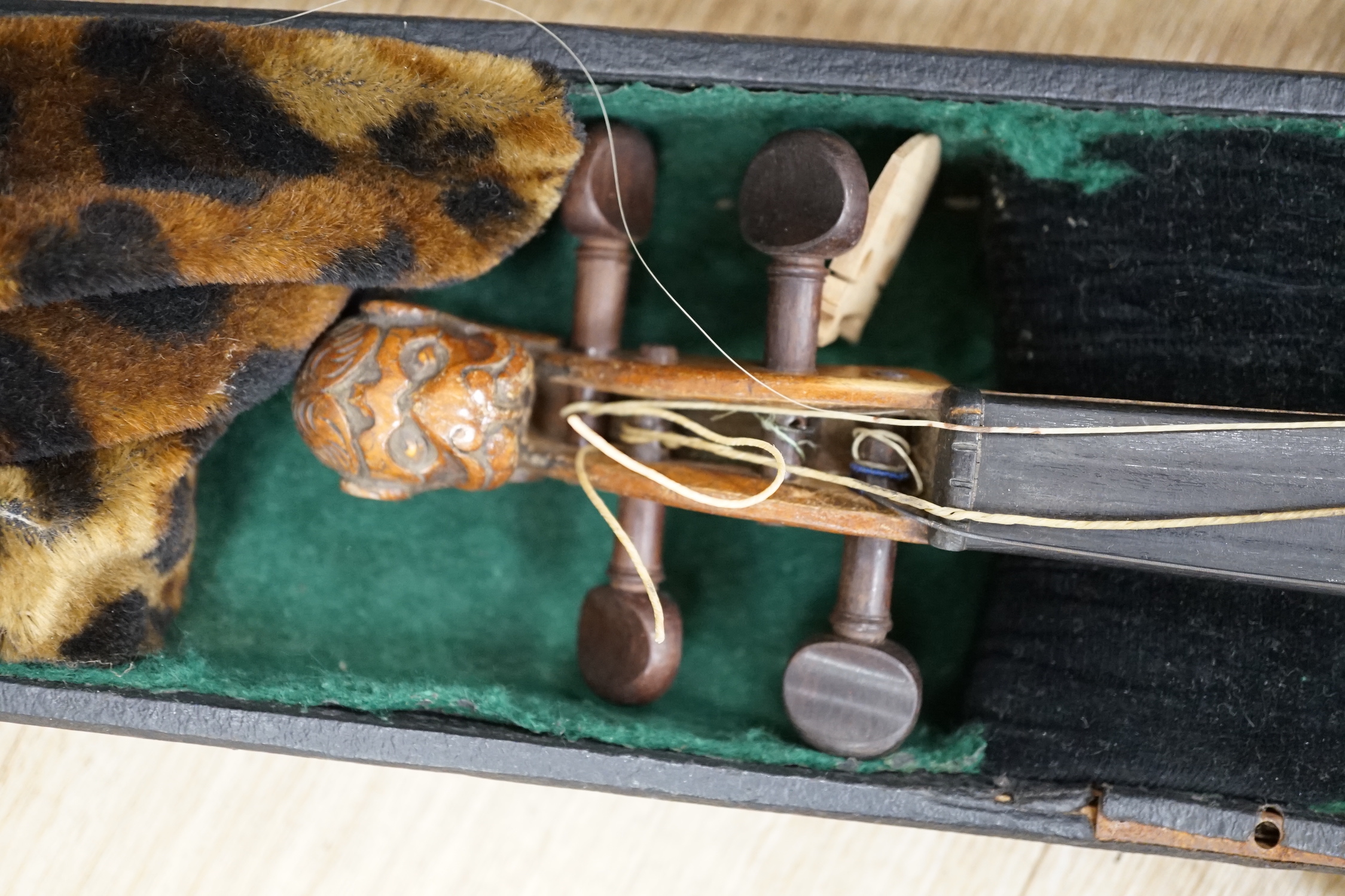 A cased 19th century Continental violin with lions head carved scroll, length of body, 35.5cm, with bow CITES Submission reference T5V8RCZY